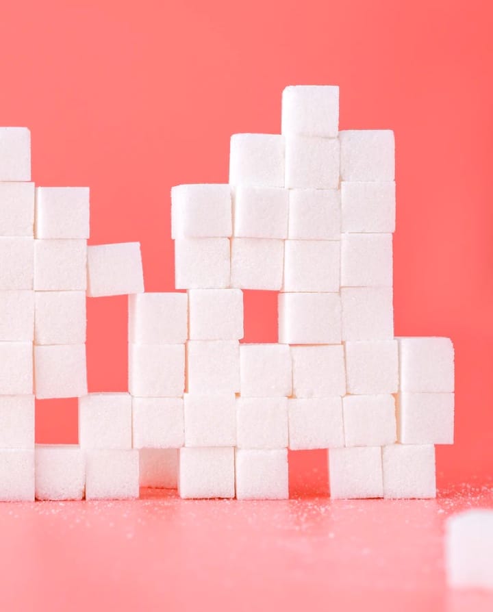 white sugar cubes on a salmon background