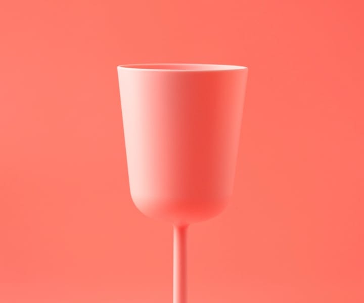 white cup on a salmon background